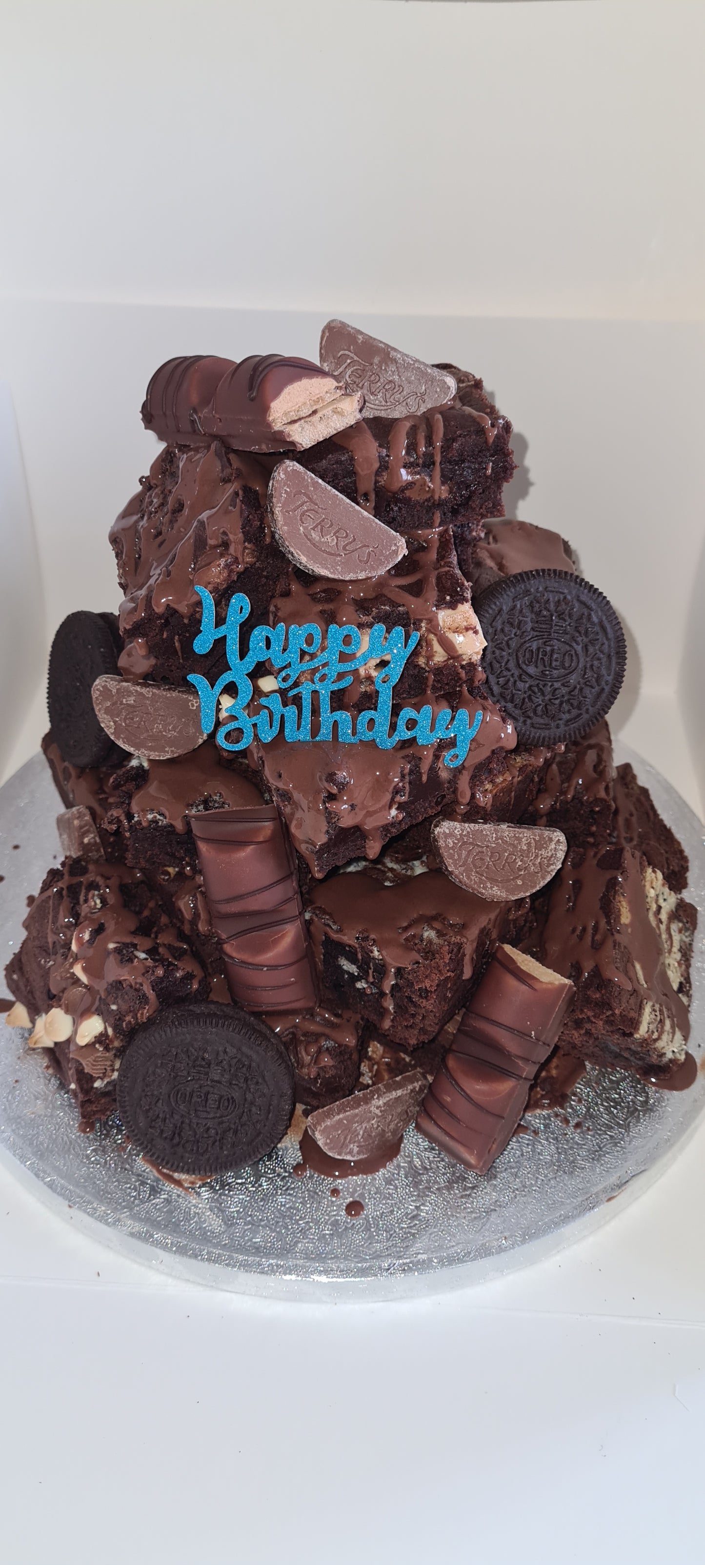 A happy birthday bespoke cake, covered in Kinder Bueno, Terrys chocolate orange and oreo!