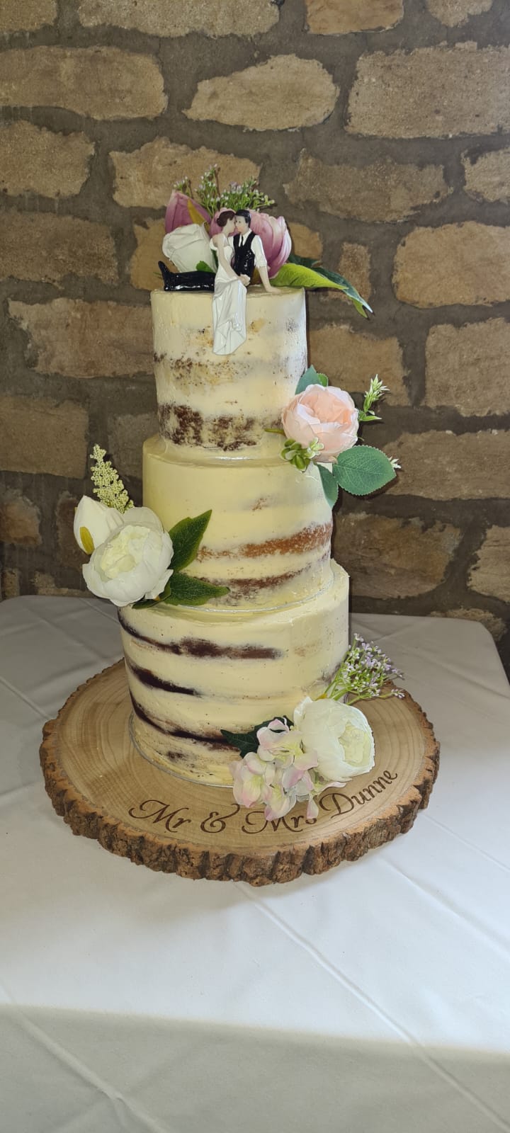 A beautiful wedding cake created for a relative of mine, a three tier cake topped with the bride and the groom.
